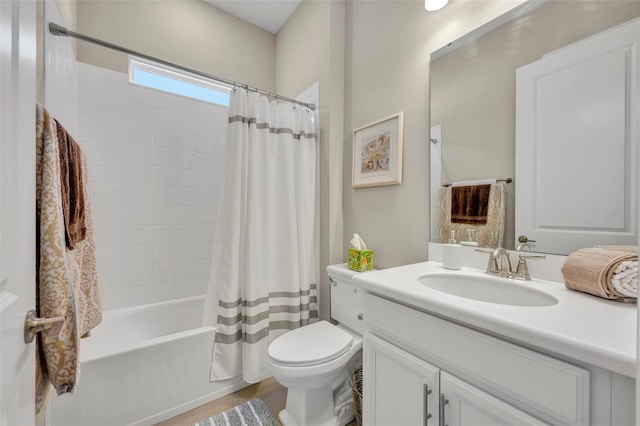 full bathroom featuring hardwood / wood-style flooring, vanity, shower / tub combo, and toilet