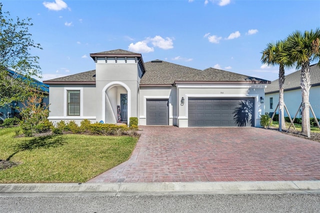 view of front facade with a front yard and a garage