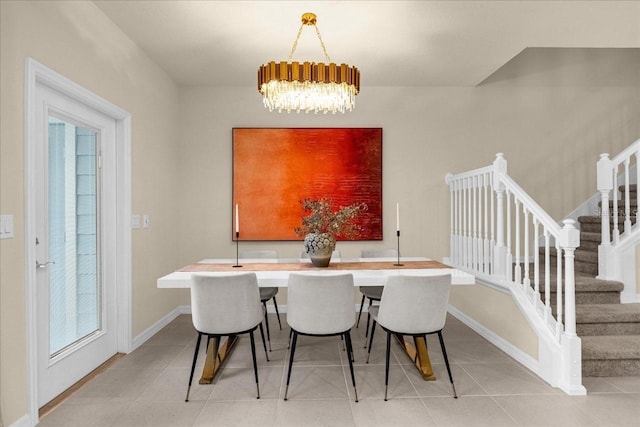 dining space with light tile patterned flooring and a chandelier