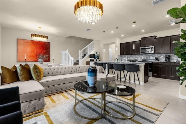 tiled living room featuring an inviting chandelier and sink