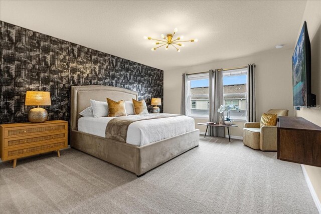 carpeted bedroom with a textured ceiling and a chandelier