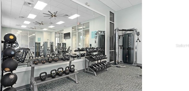 gym with a drop ceiling and ceiling fan