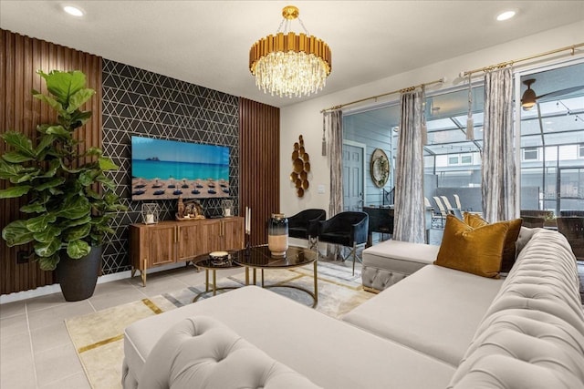 tiled living room with ceiling fan with notable chandelier