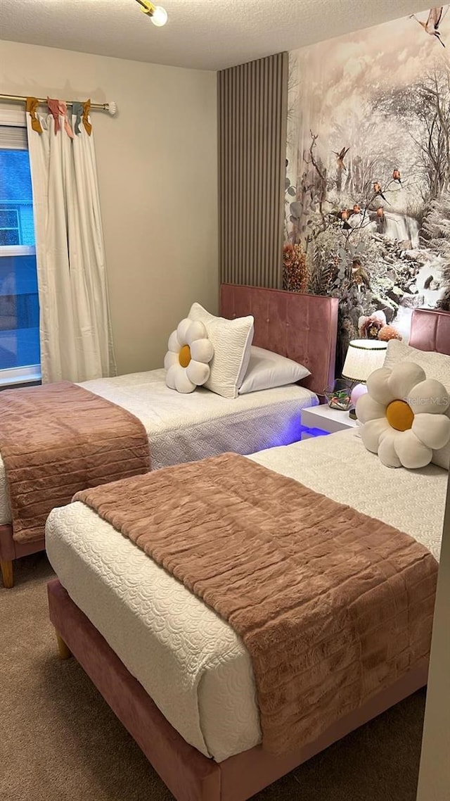 bedroom featuring carpet flooring and a textured ceiling