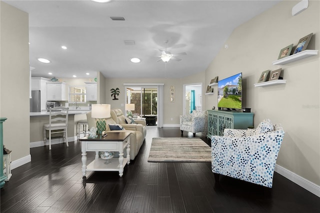 living room featuring ceiling fan, dark hardwood / wood-style flooring, and lofted ceiling