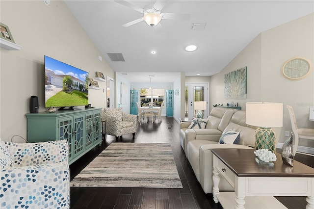 living room with ceiling fan, dark hardwood / wood-style flooring, and lofted ceiling