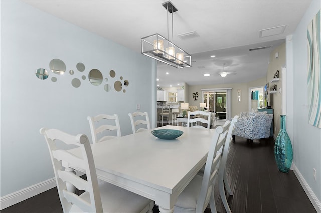 dining space featuring dark wood-type flooring