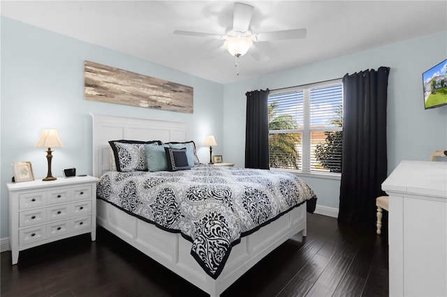 bedroom with ceiling fan and dark hardwood / wood-style flooring