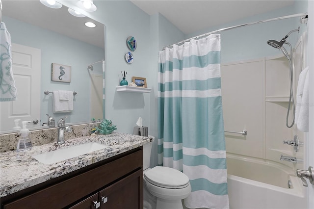 full bathroom featuring vanity, shower / tub combo, and toilet