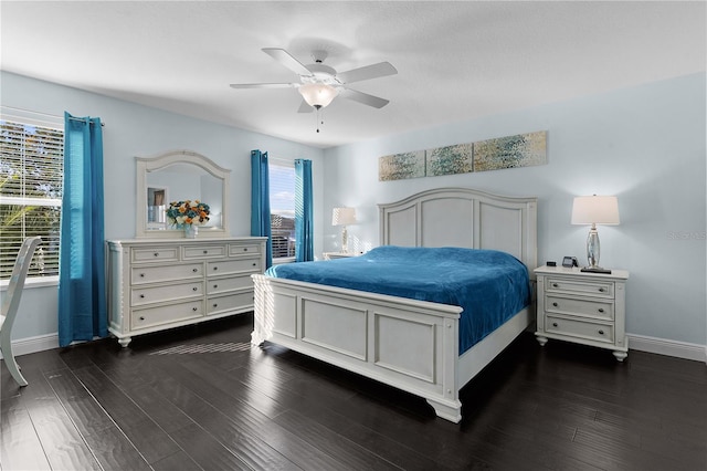 bedroom with multiple windows, ceiling fan, and dark wood-type flooring