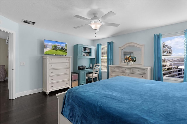 bedroom featuring a textured ceiling, ceiling fan, and dark wood-type flooring