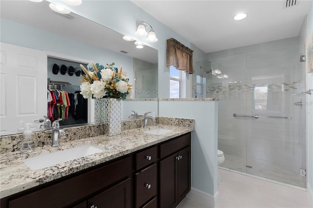 bathroom featuring vanity, toilet, and an enclosed shower