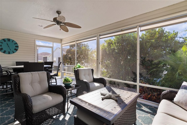 sunroom / solarium with a wealth of natural light and ceiling fan