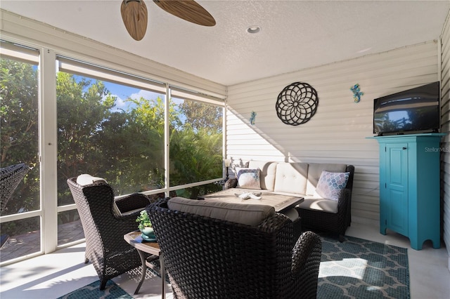 sunroom featuring ceiling fan