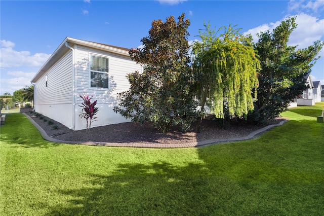 view of property exterior with a yard