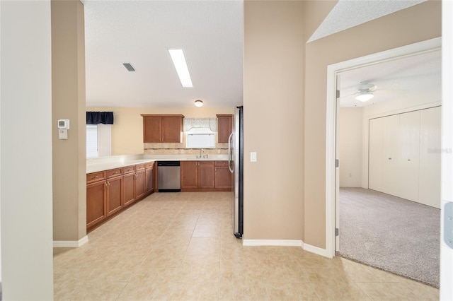 kitchen featuring ceiling fan, sink, light tile patterned floors, and stainless steel appliances