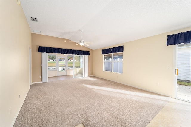 unfurnished living room featuring a textured ceiling, ceiling fan, light colored carpet, and vaulted ceiling