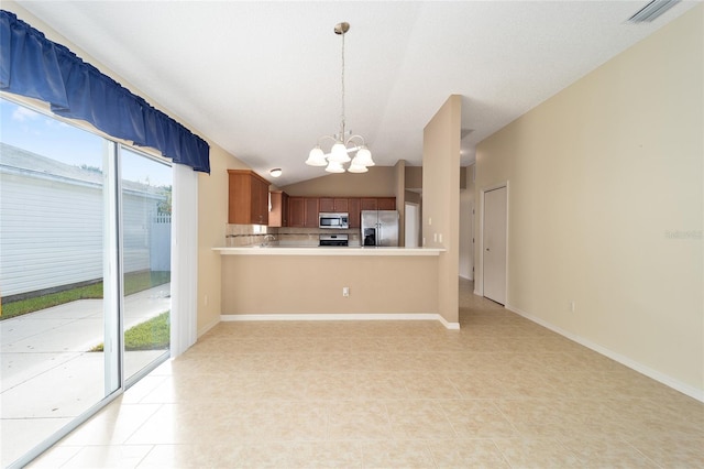 kitchen featuring an inviting chandelier, hanging light fixtures, vaulted ceiling, kitchen peninsula, and stainless steel appliances