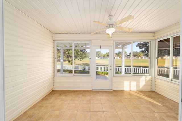 unfurnished sunroom with ceiling fan, plenty of natural light, and wooden ceiling