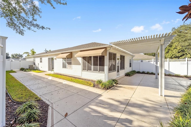 rear view of property featuring a pergola, a patio, and central air condition unit