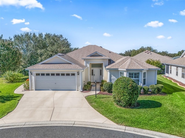 view of front of house featuring a garage and a front lawn