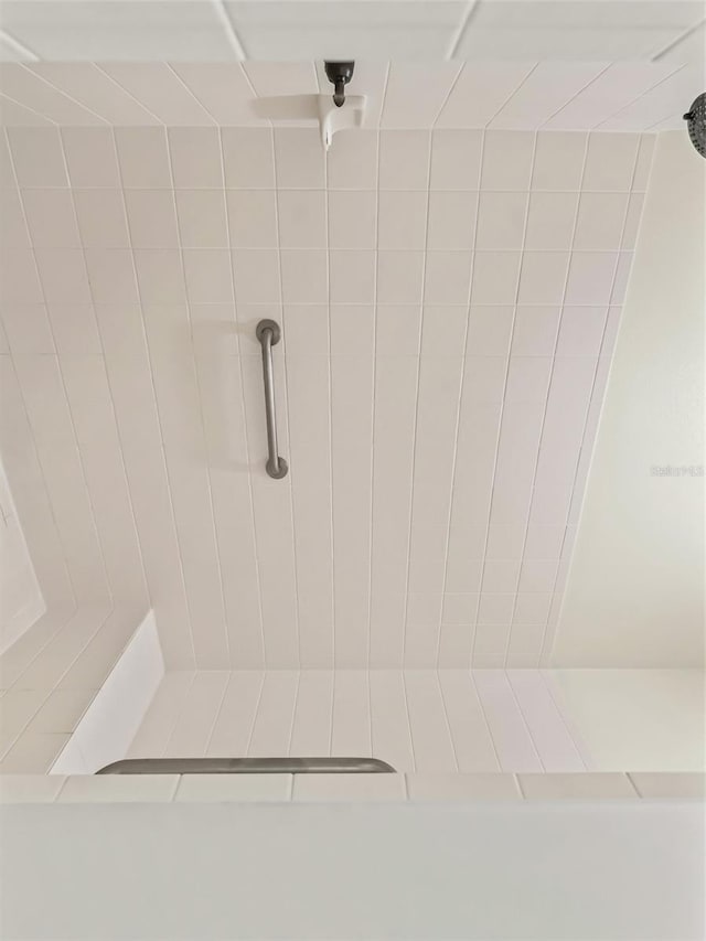 bathroom with tiled shower