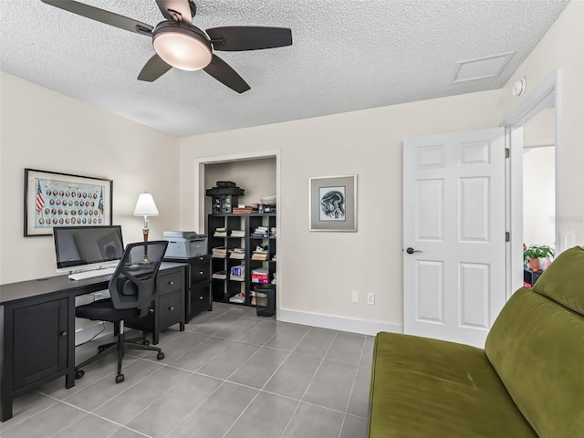 office with light tile patterned floors, a textured ceiling, and ceiling fan