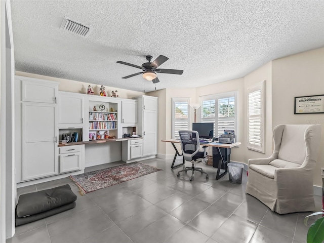 office with ceiling fan and a textured ceiling