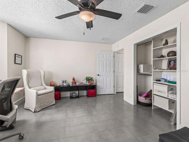 office space featuring ceiling fan and a textured ceiling