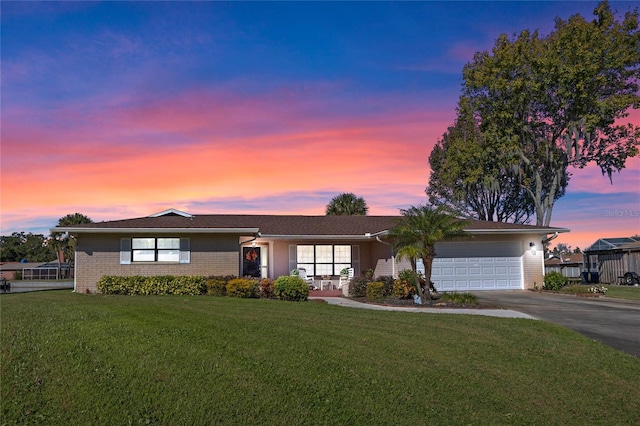 single story home with a yard and a garage