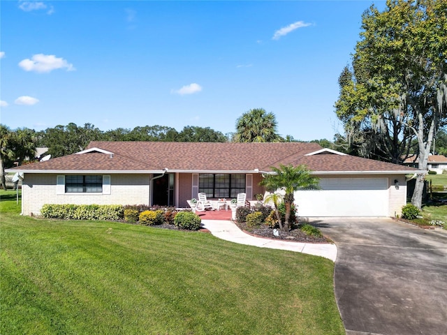 ranch-style home featuring a front yard and a garage