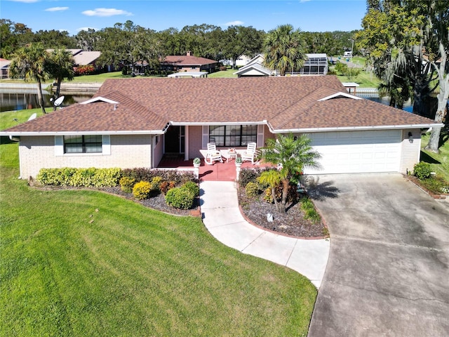 ranch-style home with a garage and a front lawn