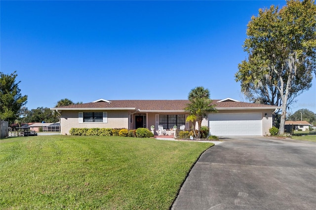 ranch-style home with a garage and a front lawn