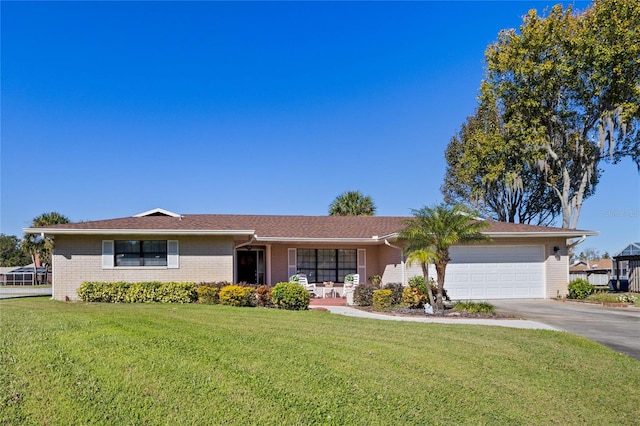 ranch-style house with a garage and a front lawn