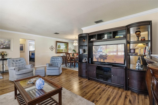 living room with a textured ceiling, hardwood / wood-style flooring, and crown molding