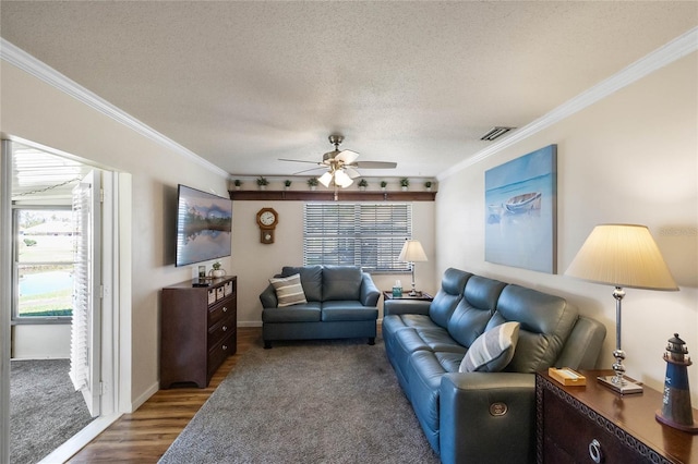 living room featuring crown molding, rail lighting, hardwood / wood-style flooring, ceiling fan, and a textured ceiling