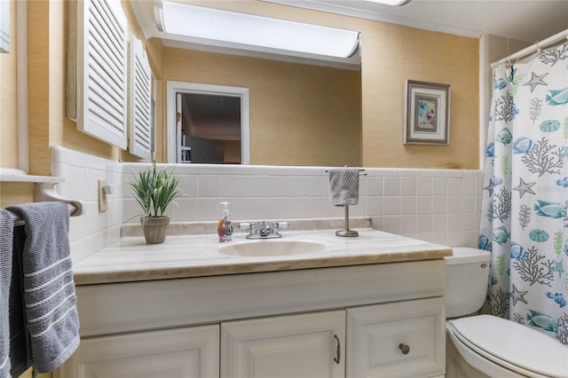 bathroom with vanity, a shower with shower curtain, tile walls, and toilet