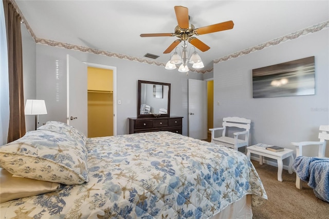 bedroom featuring carpet flooring, ceiling fan, a spacious closet, and a closet