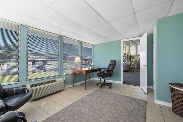 office with a drop ceiling and light tile patterned flooring