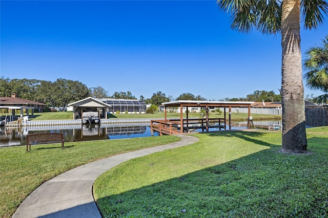 dock area featuring a water view and a yard