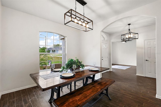 14701 Timucua Pl, Clermont, FL 34711 - dining space featuring a chandelier, arched walkways, and dark wood-style flooring