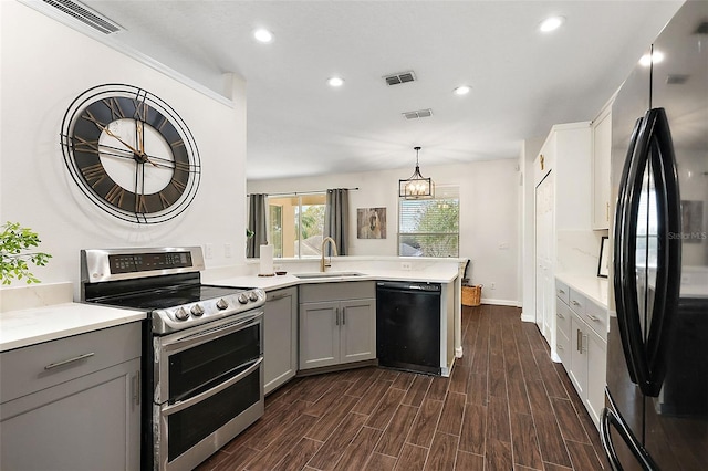 14701 Timucua Pl, Clermont, FL 34711 - kitchen with freestanding refrigerator, double oven range, black dishwasher, gray cabinetry, and recessed lighting