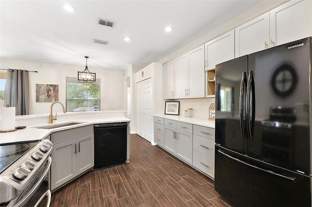 kitchen featuring dark wood-type flooring, sink, black appliances, gray cabinets, and hanging light fixtures