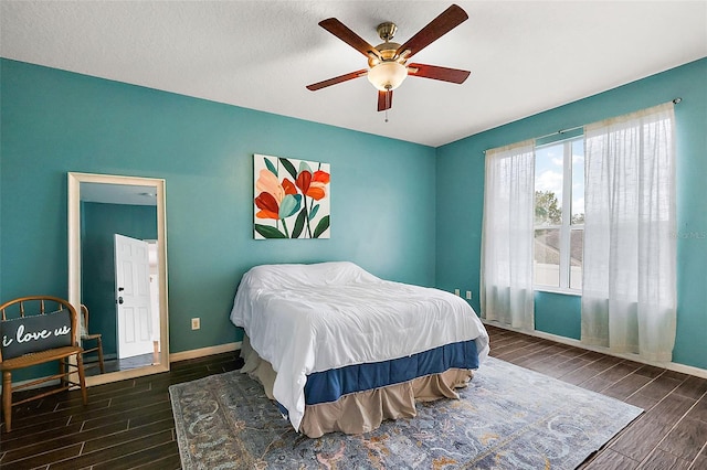 bedroom featuring a textured ceiling, dark hardwood / wood-style floors, and ceiling fan