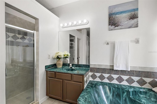 bathroom featuring tile patterned floors, vanity, and shower with separate bathtub