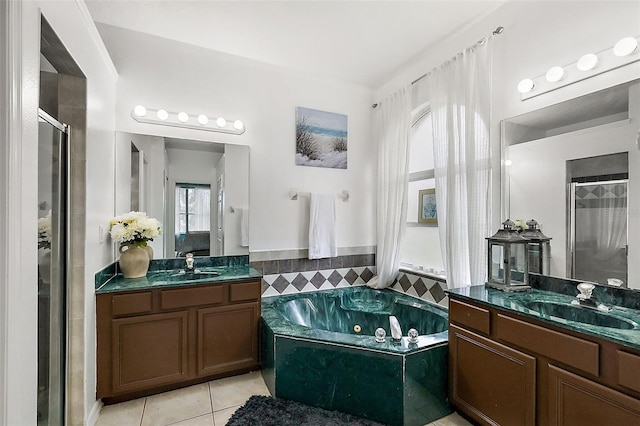 14701 Timucua Pl, Clermont, FL 34711 - full bath with tile patterned flooring, a stall shower, a jetted tub, two vanities, and tile walls