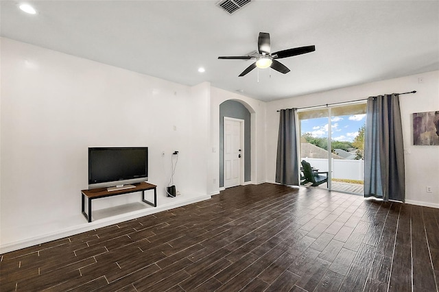 14701 Timucua Pl, Clermont, FL 34711 - unfurnished living room featuring arched walkways, dark wood finished floors, a ceiling fan, and recessed lighting