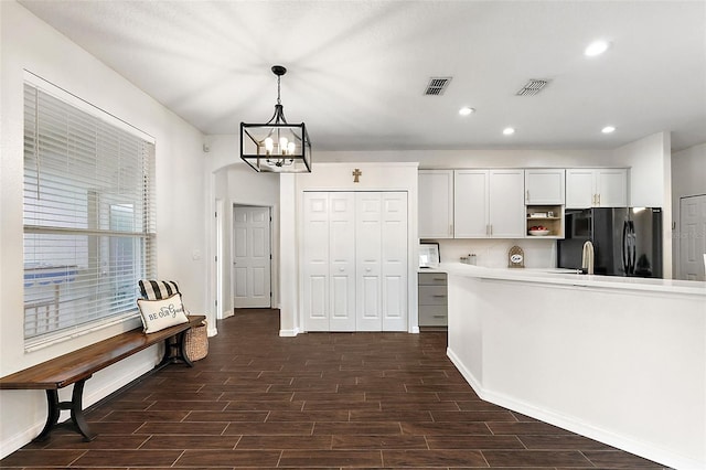 14701 Timucua Pl, Clermont, FL 34711 - kitchen featuring freestanding refrigerator, a chandelier, dark wood-type flooring, recessed lighting, and light countertops