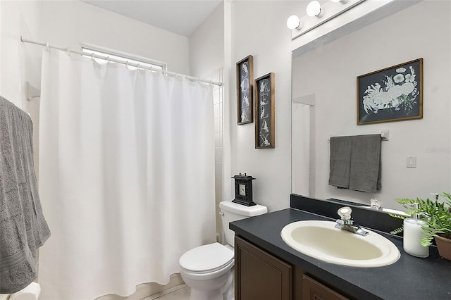 bathroom featuring tile patterned flooring, vanity, and toilet