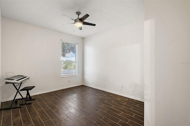 unfurnished room with ceiling fan and dark wood-type flooring